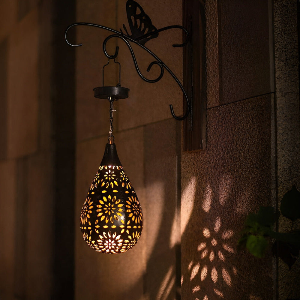 Solar Moroccan metal lantern casting patterned light